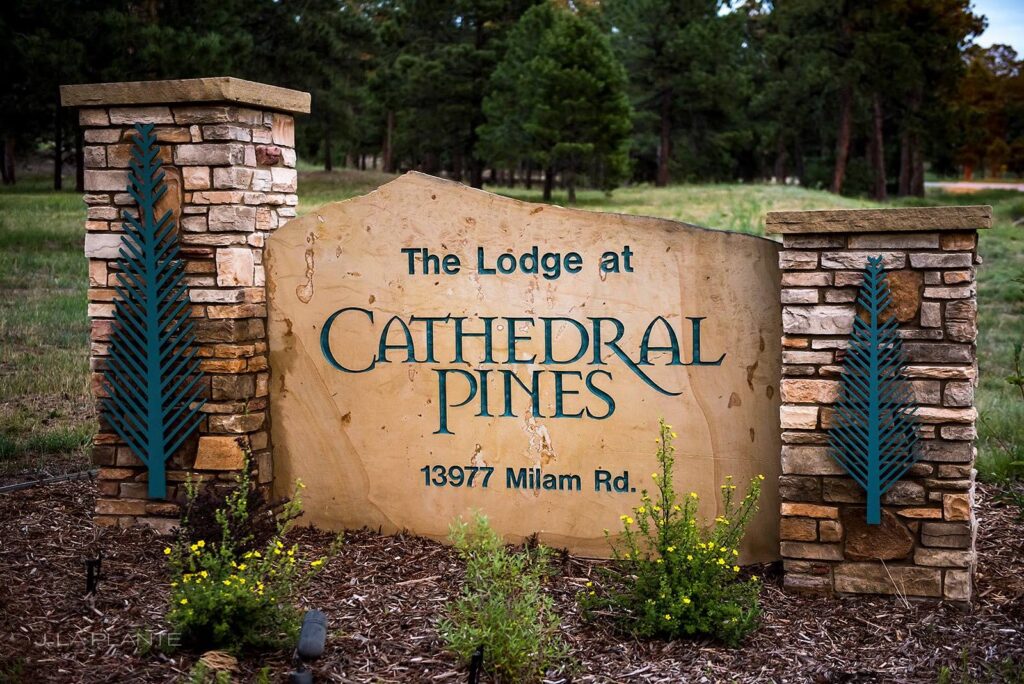 Outdoor stone sign for The Lodge at Cathedral Pines