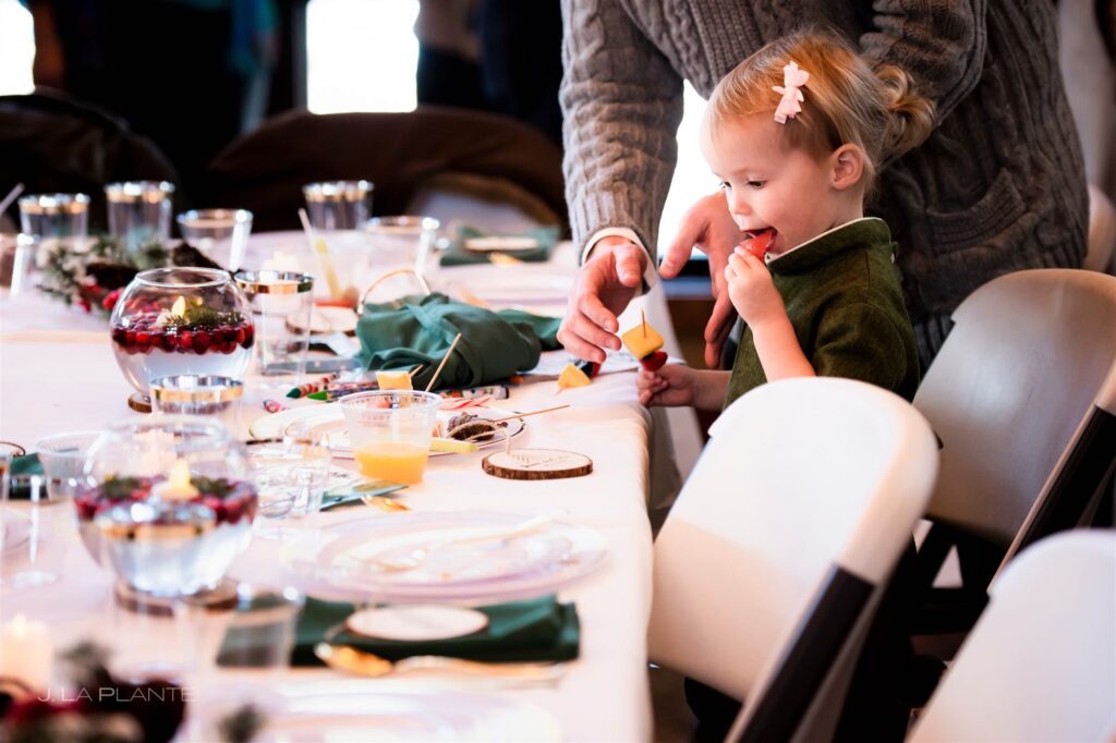 Child eating at a holiday party hosted at The Lodge at Cathedral Pines