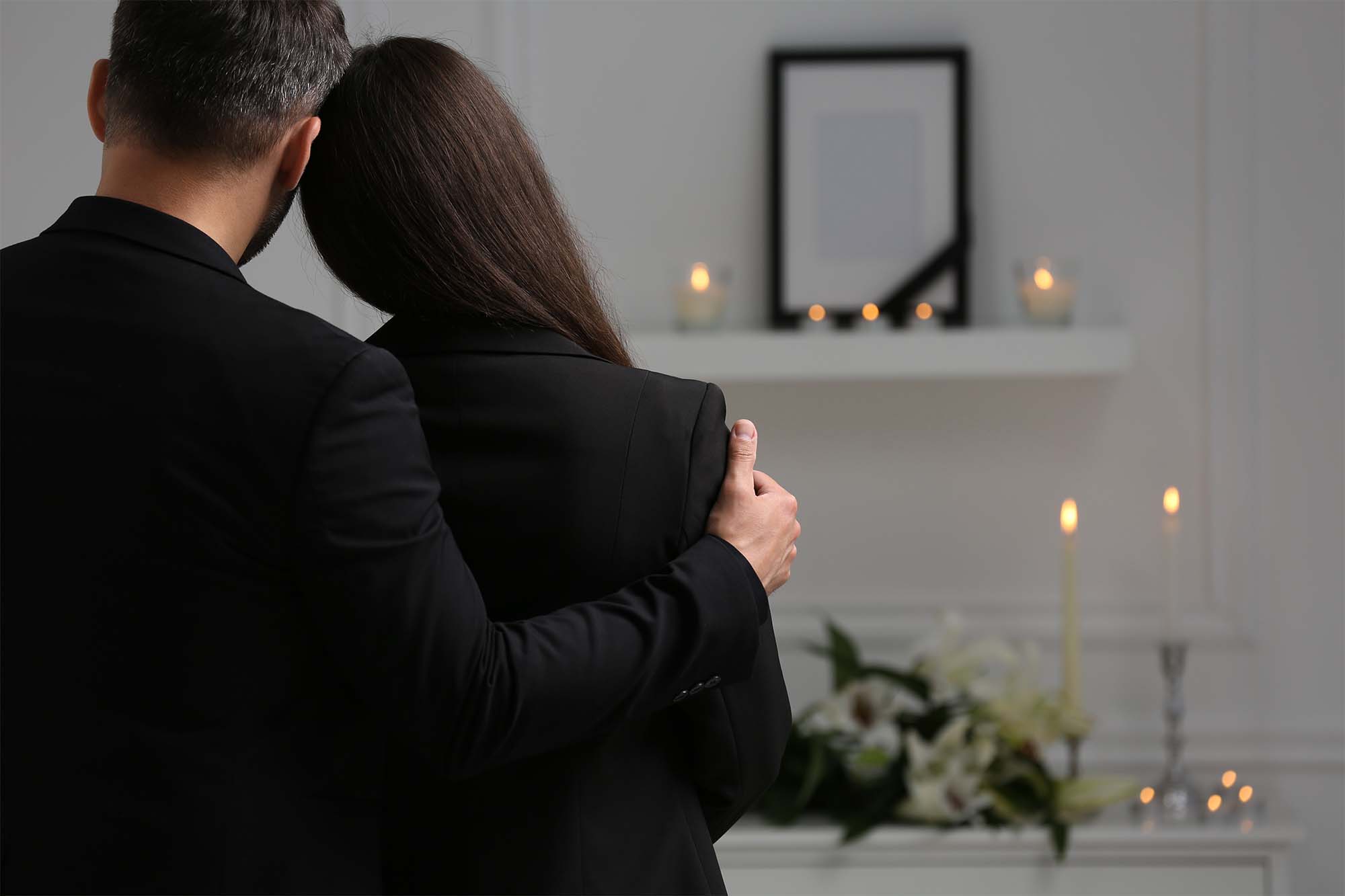 Couple mourning while deciding on having a Celebration of Life vs Funeral