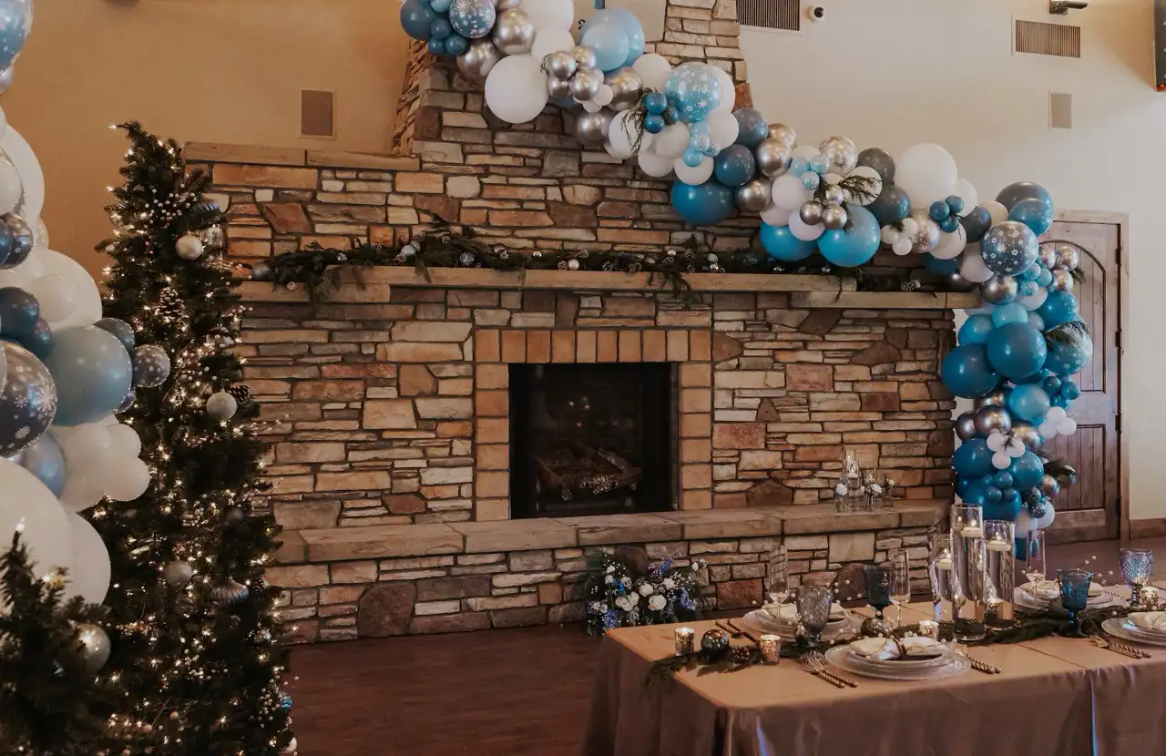 The stone fireplace at The Lodge at Cathedral Pines decorated for a corporate holiday party