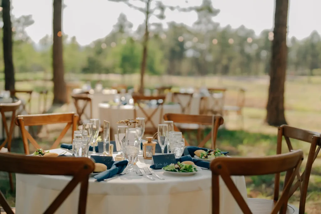 Outdoor wedding reception with beautiful dining tables