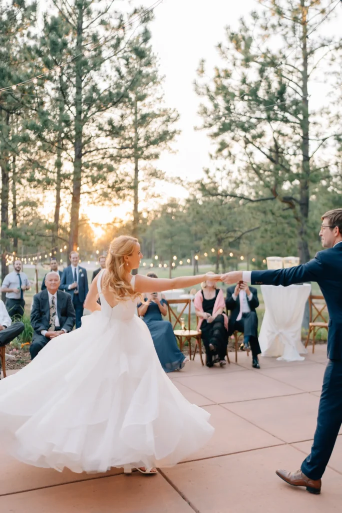 Bride and groom dance at a wedding reception outdoors at The Lodge at Cathedral Pines